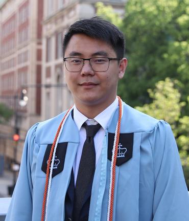 PhD student Jiaang Yao wearing graduation regalia from Columbia University